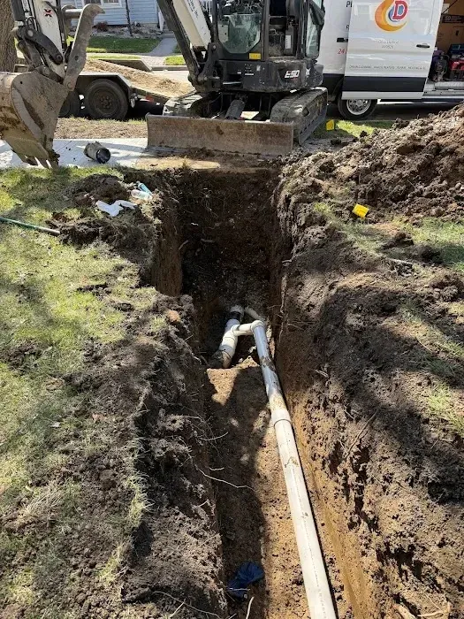 Excavated sewer line prepared for repair at a residential property